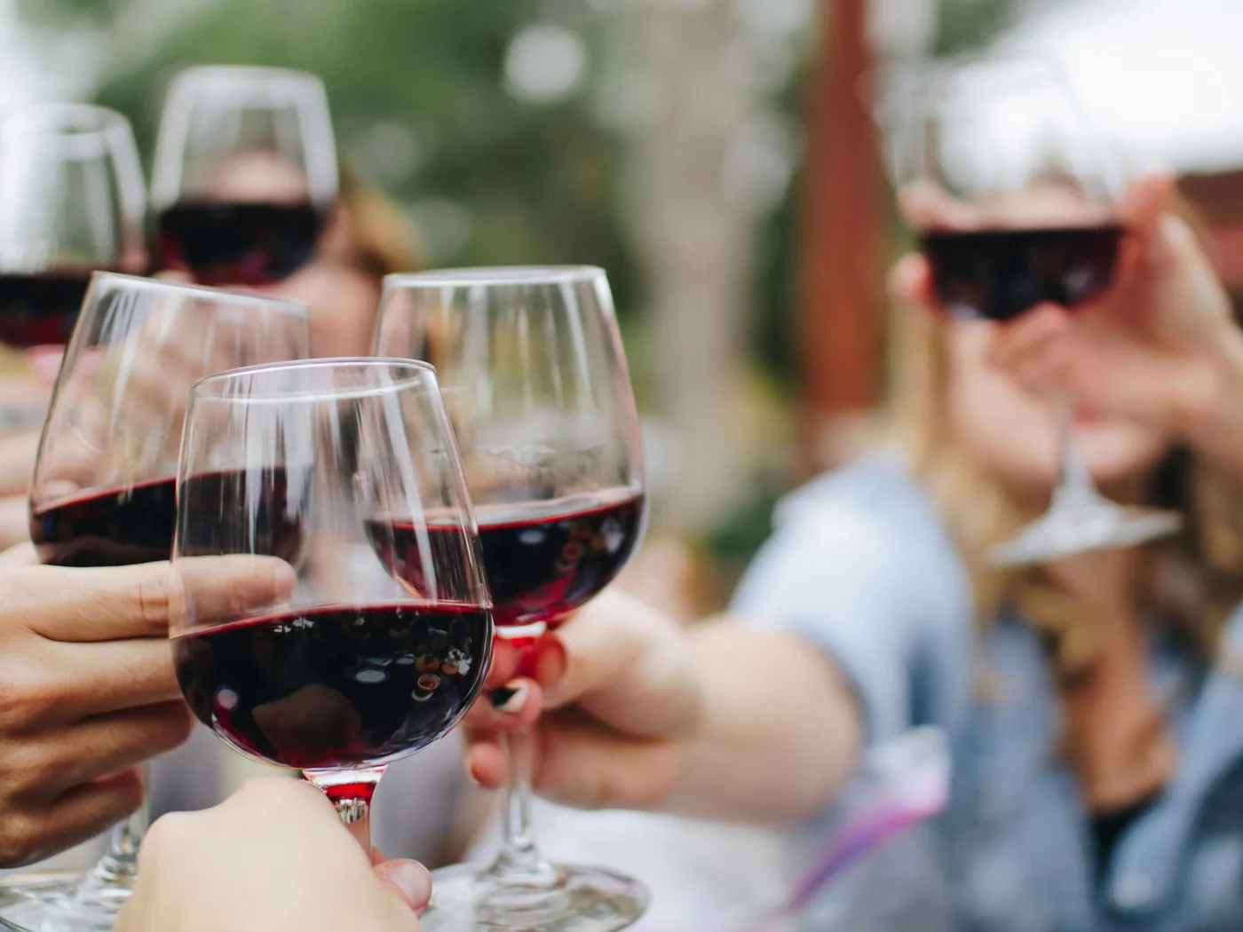 Glasses of red wine on a table with a vineyard view